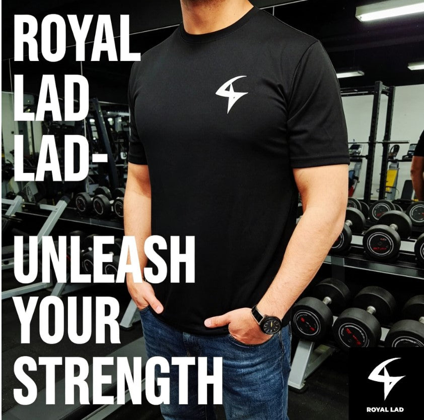 Person wearing a black t-shirt with a logo in a gym setting, featuring text 'ROYAL LAD' and 'UNLEASH YOUR STRENGTH'.